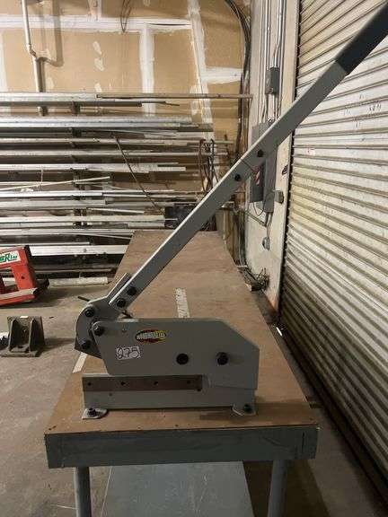 WORK BENCH WITH WHEELS AND PEGS FOR STATIONARY USE, WITH WOODWARD FAB FASTENER TOOL ATTACHED TO TABLE