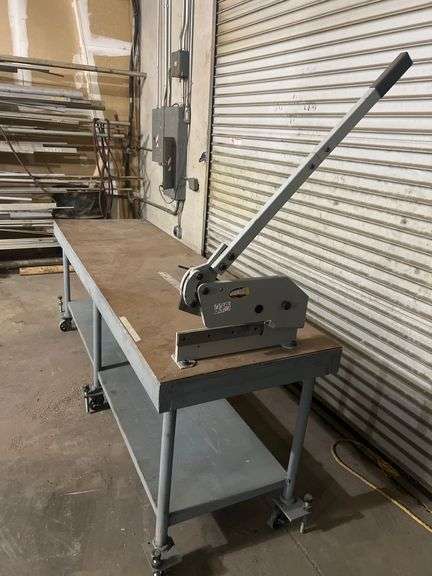 WORK BENCH WITH WHEELS AND PEGS FOR STATIONARY USE, WITH WOODWARD FAB FASTENER TOOL ATTACHED TO TABLE