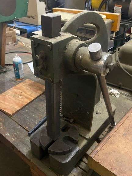 UNITED YUASA INTERNATIONAL INC. 595-00 ARBOR PRESS MOUNTED TO TABLE BUYER RESPONSIBLE TO REMOVE