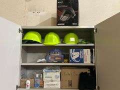 PPE STORAGE CABINET WITH VARIOUS SAFETY EQUIPMENT SUCH AS FACE MASKS, KIDNEY BELTS, HARD HATS, UVEX A800 CLEAR LENS GLASSES ECT CABINET IS APROX 35"x14"x30"