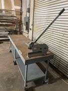 WORK BENCH WITH WHEELS AND PEGS FOR STATIONARY USE, WITH WOODWARD FAB FASTENER TOOL ATTACHED TO TABLE