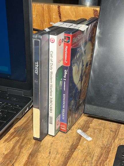 VIDEO GAMES INCLUDING PS2 KINGDOM OF HEARTS, XBOX 360 COD MW3 ; AND XBOX ONE THIEF IN METAL CASE