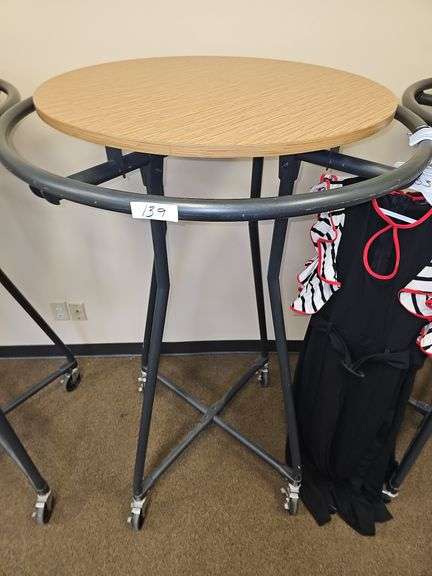 ROLLING BLACK METAL CLOTHING RACKS WITH REMOVABLE WOODEN TOP, APROX 3' DIA. HANGER RACK, 30" WOODEN TOP, AND 58"H ON WHEELS WITH BRAKES