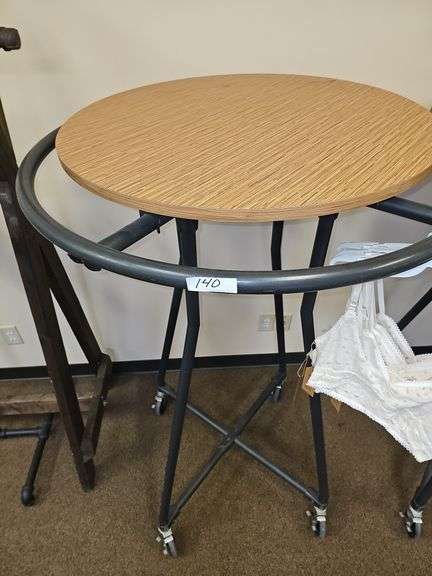 ROLLING BLACK METAL CLOTHING RACKS WITH REMOVABLE WOODEN TOP, APROX 3' DIA. HANGER RACK, 30" WOODEN TOP, AND 58"H ON WHEELS WITH BRAKES