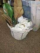 RAW WOOD DÉCOR STICKS AND LARGE FAUX FOLIAGE WITH WHITE FLOWER