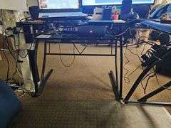 GLASS TOPPED METAL L-SHAPED OFFICE DESK WITH SINGLE SHELF, APROX 4'x4'x3' **Need tools for disassembly