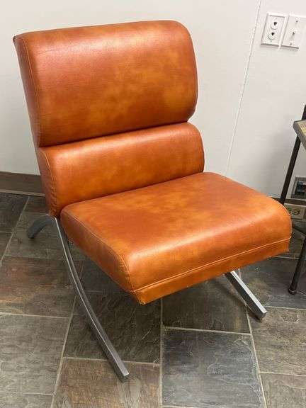 Modern brown leather and chrome chair with a sleek, minimalist design.