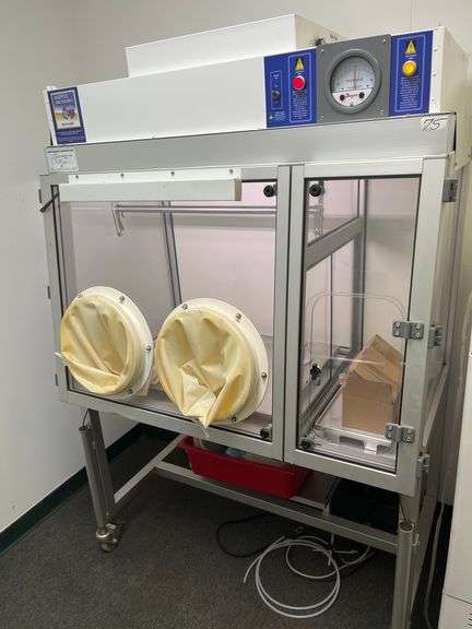 Class III Biosafety Cabinet or a specialized Aseptic Enclosure, Dwyer Photohelic® Pressure Monitor, Glove Ports, Control panel, mobile stand. Retails $8k