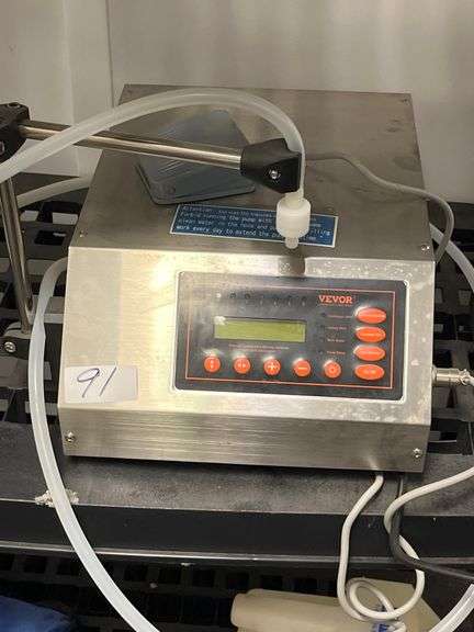 VEVOR automatic liquid filling machine, model GFK-160, features a stainless steel housing and a digital control panel w/ lcd screen. 5ml and 3500ml.