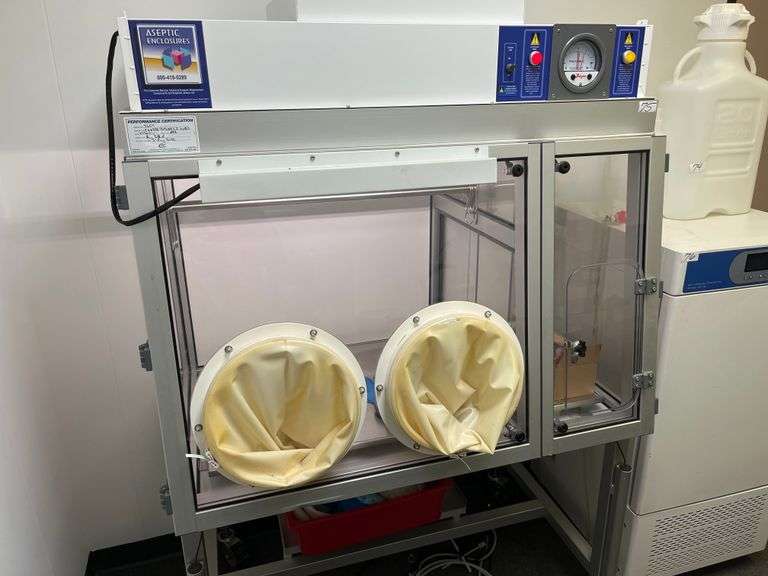 Class III Biosafety Cabinet or a specialized Aseptic Enclosure, Dwyer Photohelic® Pressure Monitor, Glove Ports, Control panel, mobile stand. Retails $8k