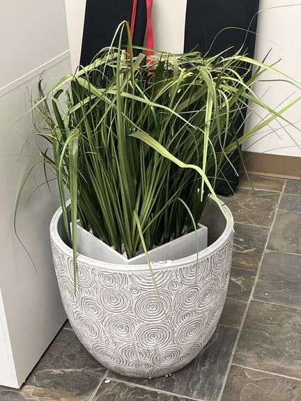 Artificial grass in a strawgrass planter features lush blades and a decorative white pot