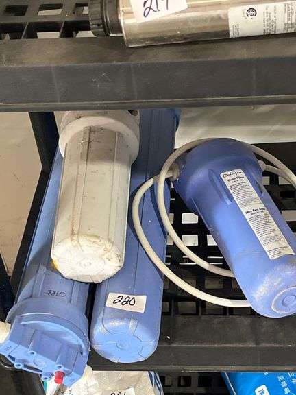 Culligan water filter housing system featuring white inlet and outlet hoses.