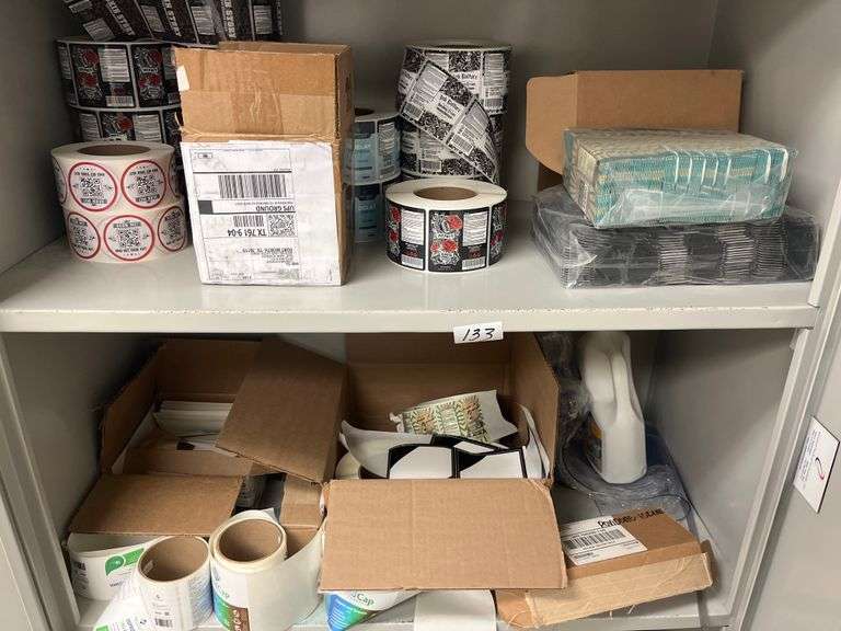 Shelf lot containing DLK Medical Solutions hand sanitizer wipes, rolls of shipping labels