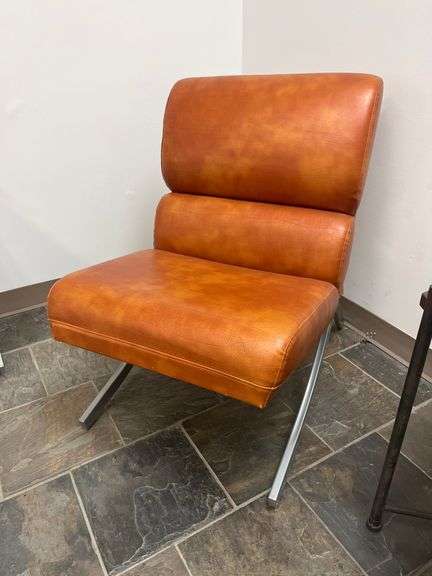 Modern brown leather and chrome chair with a sleek, minimalist design.