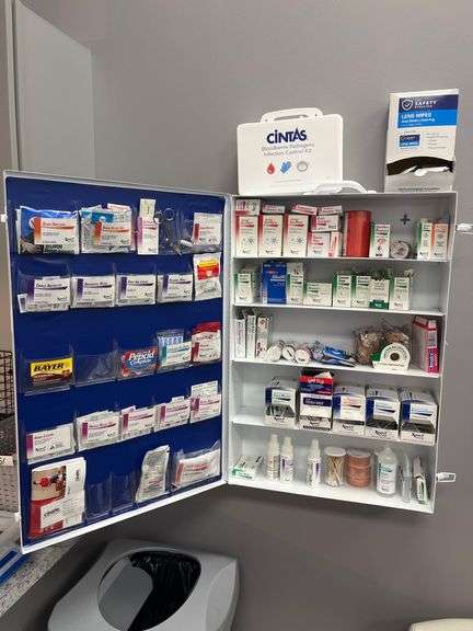 CINTAS FIRST AID CENTER CABINET FULL OF BURN DRESSING, LIQUID BANDAGE, XPECT ANTACID , COUGH DROPS, ICE PACKS, ETC
