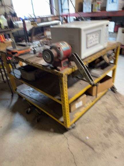 48“ x 48“ steel shop table on wheels with bench grinder and old belt sander with contents 