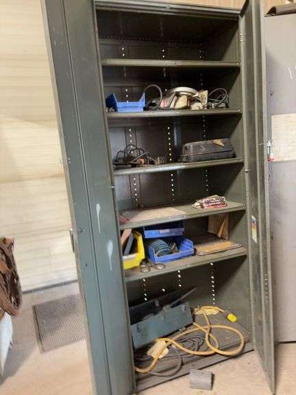 Metal storage cabinet 7 foot high 36 inch wide with contents electric cord electric saw air hose 